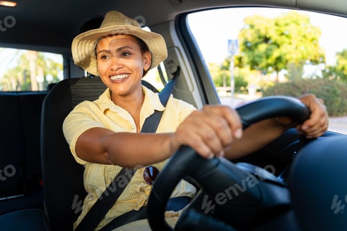 Preview: Woman feeling joy while driving car on a sunny day, promoting road safety