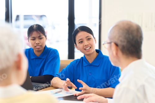 Preview: Southeast Asian caregiver explaining to Japanese senior