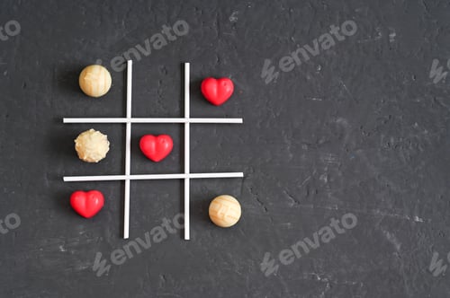 Preview: Creative tic-tac-toe game with red heart shapes and small round candies