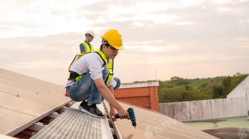 Preview: Engineer service check installation solar cell on the roof of factory. Silhouette technician inspect