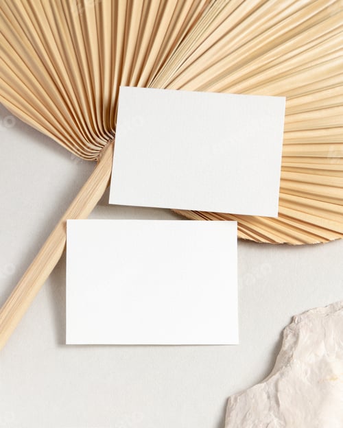 Preview: Blank sided cards set mockup with dried palm leaf on beige stone top view, wedding stationery