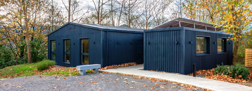 Preview: Sustainable coworking office building using shipping containers and solar panels located in a forest