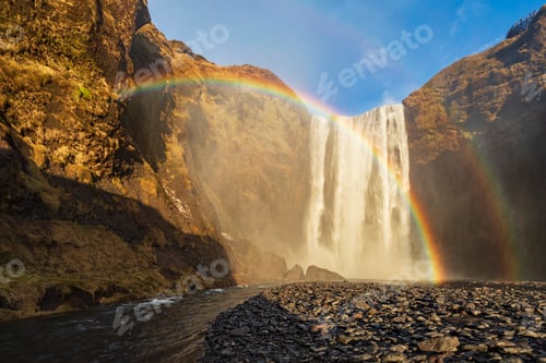 Preview: Skagafoss waterfall, cliffs and a Double Rainbow, a cascade falling into a pool.