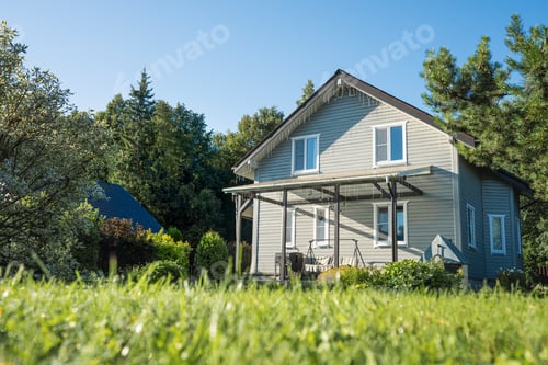 Preview: Modern suburban house with lawn viewed from grass level