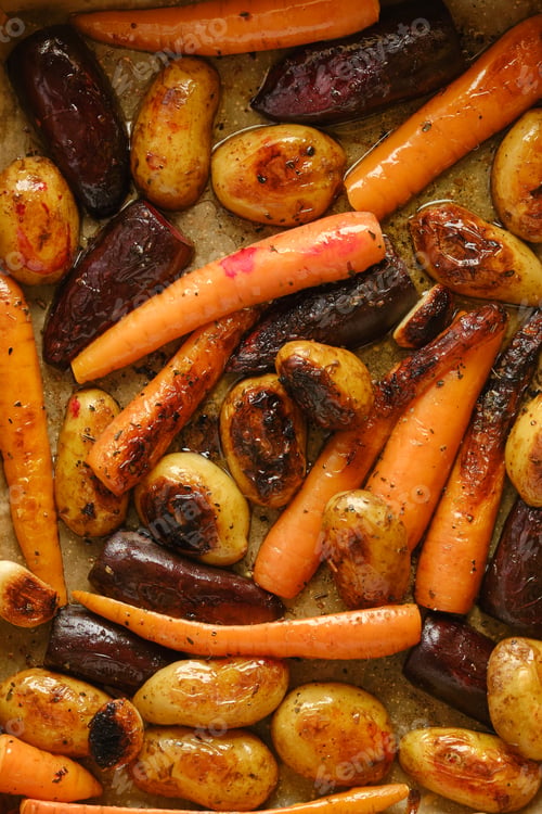 Preview: Roasted vegetables with carrots, potatoes and beetroot on baking tray in kitchen setting