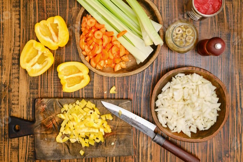 Preview: Chopping vegetables for a healthy meal with yellow pepper, celery, carrots, and onions