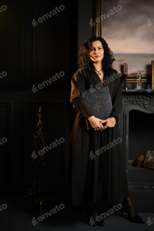 Preview: Woman holding a book standing near a fireplace in a dark room with a painting on the wall