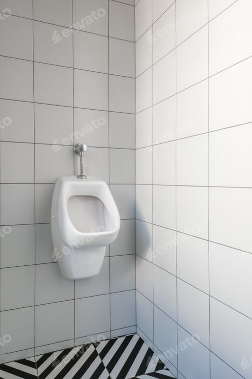 Preview: Men's restroom with white tiles and wall-mounted urinal in modern design setting