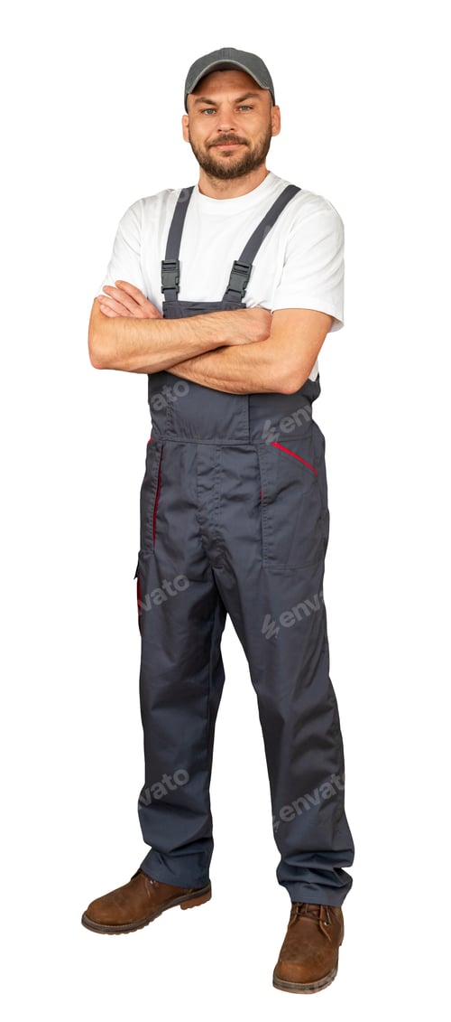 Preview: Handyman with crossed arms posing in grey bib overalls and cap.