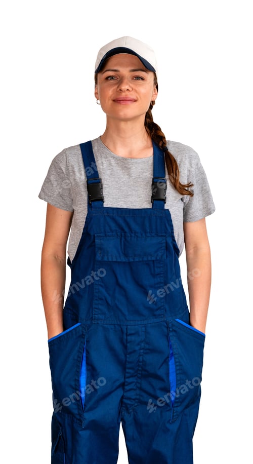 Preview: Adult female blue-collar worker wearing blue bib overalls and cap standing with hands in pockets.