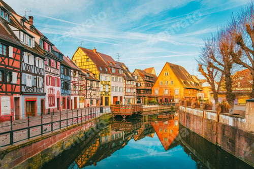 Preview: Colmar canal at morning with dramatic orange sunrise and dark facades in Alsace France