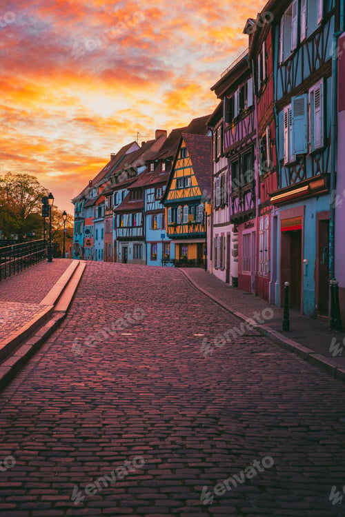 Preview: Empty Colmar square at dawn with half-timbered facades in orange light
