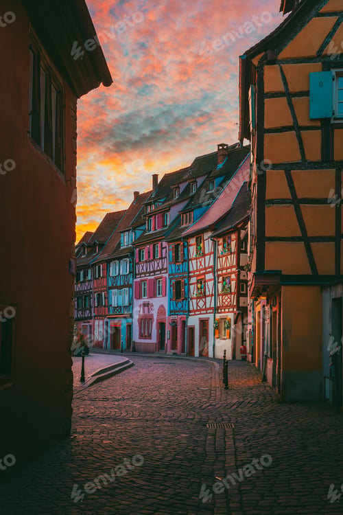 Preview: Soft pink dawn sky reflected in Colmar canal with silent waterfront in Alsace France