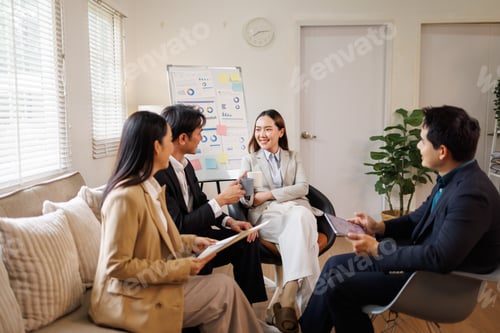 Preview: Business team collaborating during meeting in modern office