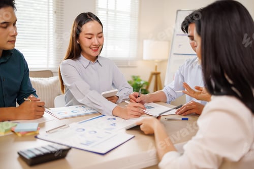 Preview: Business team analyzing data charts during office meeting