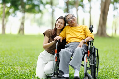 Preview: Young woman providing loving support for an elderly asian woman sitting in a wheelchair, enjoying ti