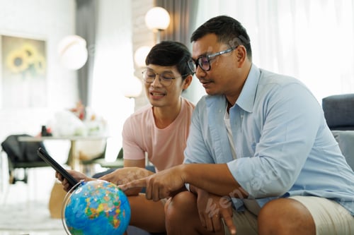 Preview: Asian gay couple choosing vacation destination on a globe, planning future holiday travel at home, d