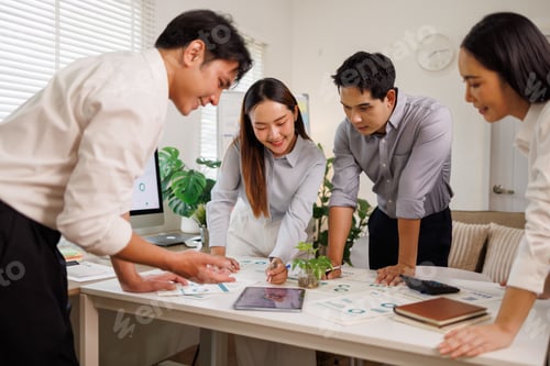 Preview: Business team analyzing data and planning strategy in office