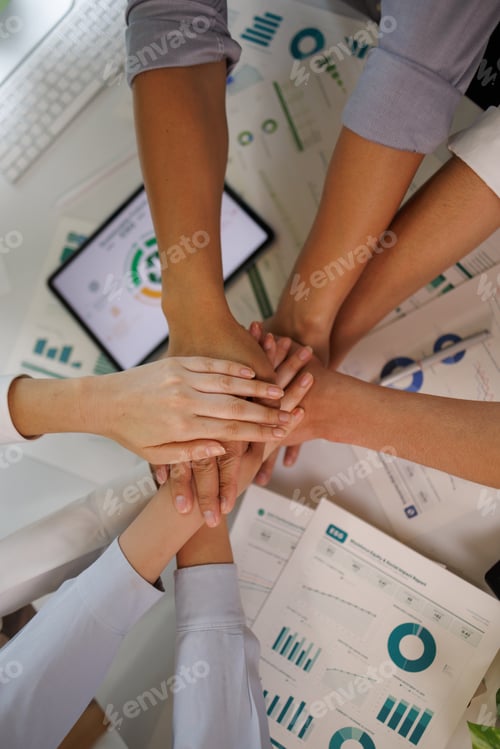 Preview: Business team stacking hands showing unity and partnership