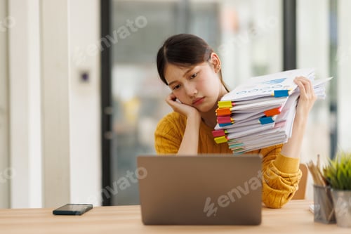 Preview: Young woman feeling overwhelmed with deadlines and excessive paperwork