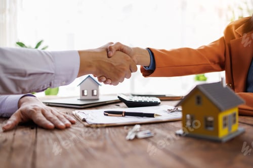 Preview: Real estate agents shaking hands closing home deal