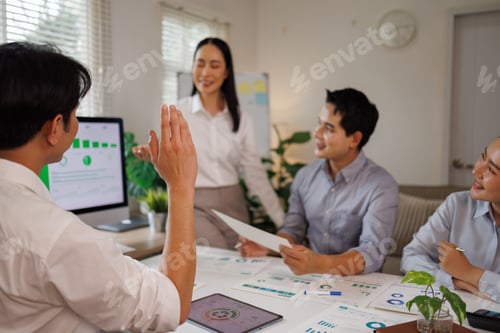 Preview: Business team analyzing green energy data during meeting