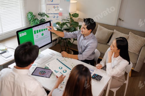 Preview: Business team analyzing esg investment reports on computer
