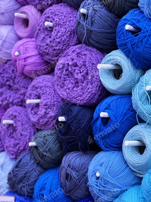 Preview: Blue and purple knitting yarn on shelf close-up background
