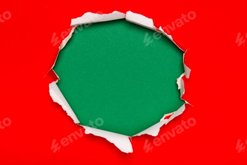 Preview: Creative Ripped Paper Hole on Red Background Revealing Green Texture