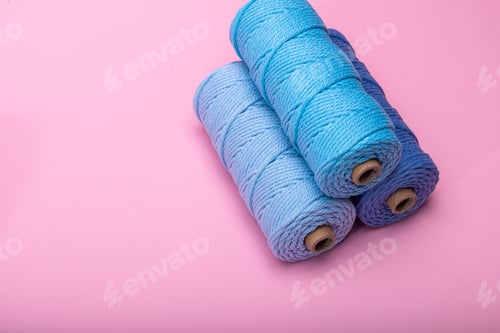 Preview: Three spools of woven cord in different shades of blue, displayed on a bright pink backdrop.