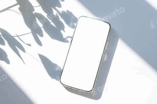 Preview: Minimal flat lay with mobile phone and leaves shadows on white background. Top view, mockup