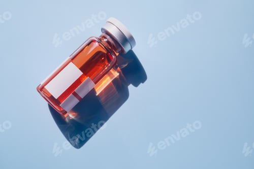 Preview: Medical vial containing orange liquid with blank labels reflects on blue surface