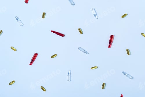 Preview: Scattered red and clear ampoules with yellow soft gel capsules for health and medicine