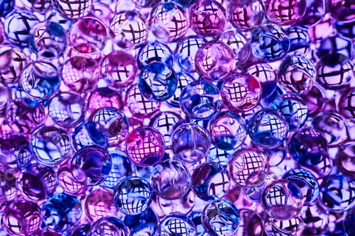 Preview: Transparent glass or gel balls with reflection of mesh grid inside each ball, illuminated in blue-vi