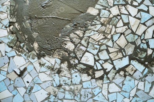 Preview: Broken ceramic tiles forming rough mosaic pattern with fresh cement. Upcycling old materials. DIY mo