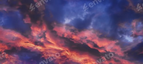 Preview: Dramatic cloudy sky painted with vibrant orange and purple colors at dusk