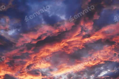 Preview: Colorful evening sky with orange and purple cumulus clouds creating dramatic background