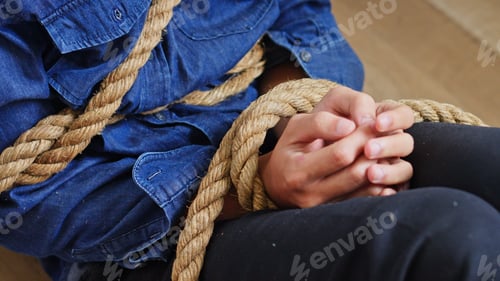 Preview: Close Up Of Hands And Torso Tied Securely By Thick Rough Rope