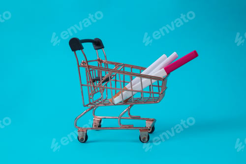 Preview: Shopping Cart Carrying Cigarettes And A Pregnancy Test On A Blue Background