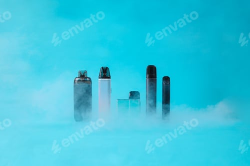 Preview: Front View Of Various Electronic Cigarettes Standing On Blue Background