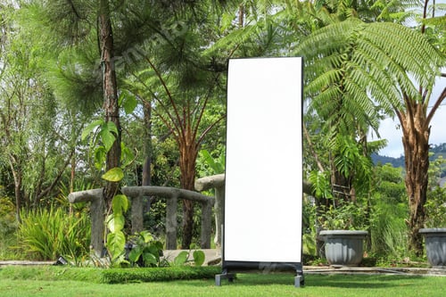 Preview: Blank Sign Board Stands On The Grass In A Lush Tropical Garden