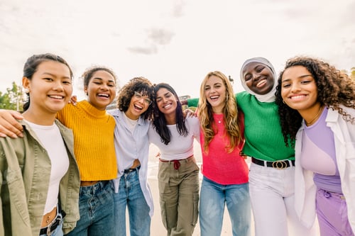 Preview: Group of women embracing and sharing joyful smiles.