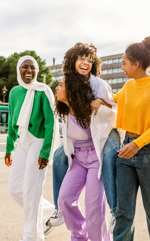 Preview: Happy diverse women walking and laughing together outdoors