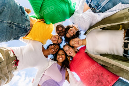 Preview: Diverse female friends looking down in a circle smiling