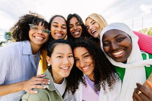 Preview: Group portrait of happy diverse women standing together