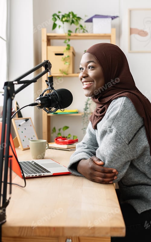 Preview: Young african muslim woman recording radio podcast from home studio