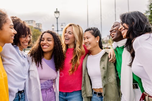 Preview: Women friends laughing and embracing outdoors