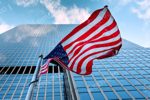Preview: Flag of United States waving in wind outside tall glass building an urban area