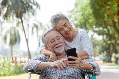 Preview: Close up of Asian Elderly Women Smiling Mature Woman With Men Sitting in Wheel Chair in the Park. F