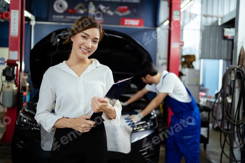 Preview: Portrait of a happy Asian female customer in a car repair shop that shows the customer's trust and s